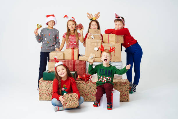 istock Children and stack of christmas present 892701212