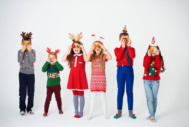 istock Playful children holding bow in front of eyes 892701374