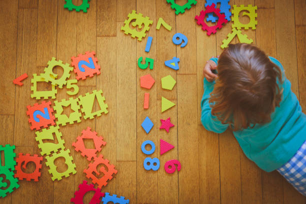 istock little girl learning numbers, education concept 892701696