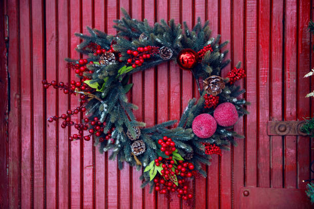 istock pine garland for Christmas hanging on red 892701946