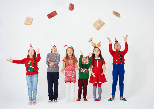 istock Cheerful children throwing their gift 892706306