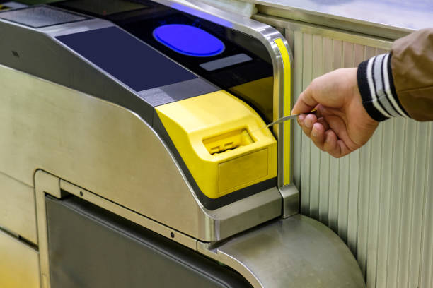 istock Man hand inserting ticket subway card in entrance 892707080