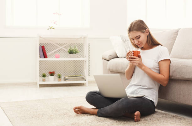 istock Young girl with laptop indoors 892711886