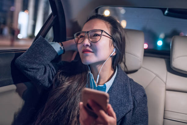 istock Woman with mobile phone in a car 892716616