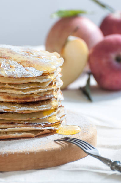 istock Apple pancakes with honey on a wooden board. 892722608