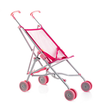 Little pink baby carriage or doll stroller isolated on white.