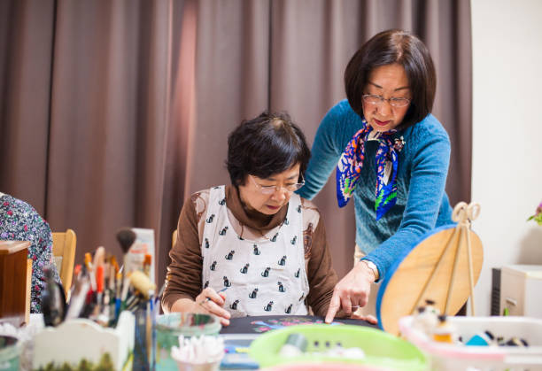 istock Senior women taking a painting class at a nursing home 892723006