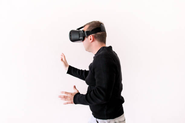 istock Handsome man wearing and playing virtual reality on isolated white background. Boy action in virtual reality helmet. VR glasses. VR Box, VR headset. Young business man at office and using Vr Box. 892726576