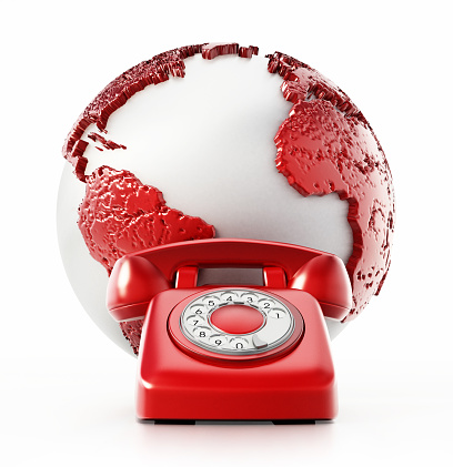 One red and white vintage telephones standing around the globe.\n\n\n