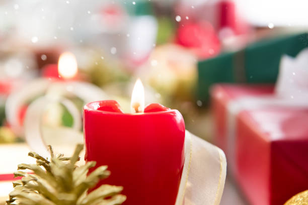 istock Red candle with Christmas gifts 892732702