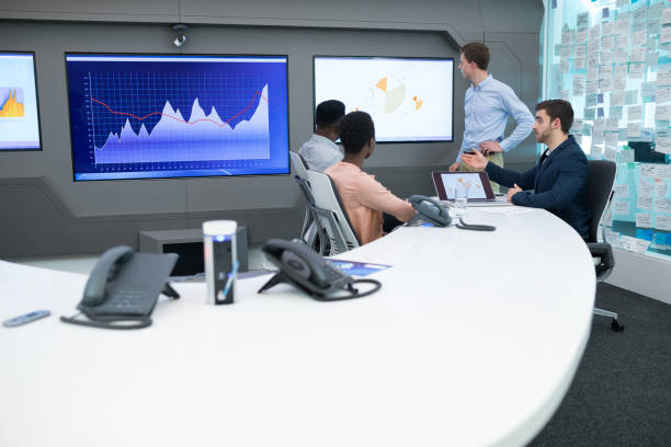istock Male and female executives discussing over graph 892732768