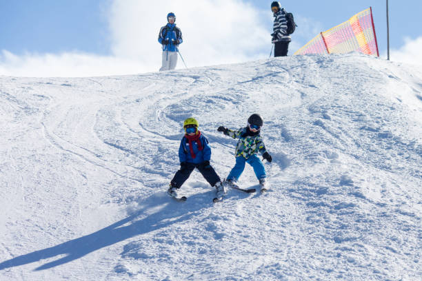 istock Two young children, siblings brothers, skiing in Austrian mountains on a sunny day 892736672