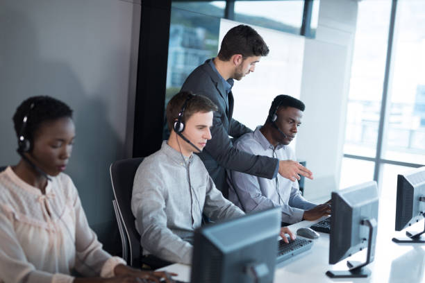 istock Customer service executive trainer monitoring her team 892736704