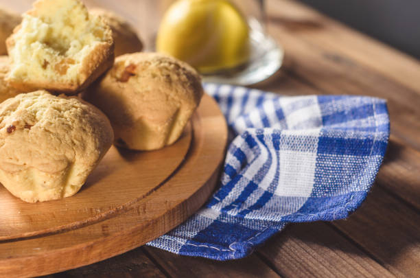 istock Lemon cupcakes on a wooden Board on the table with a blue towel 892739162