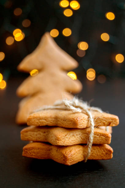 istock Cookies star-shaped folded slide on the background lights. 892742612