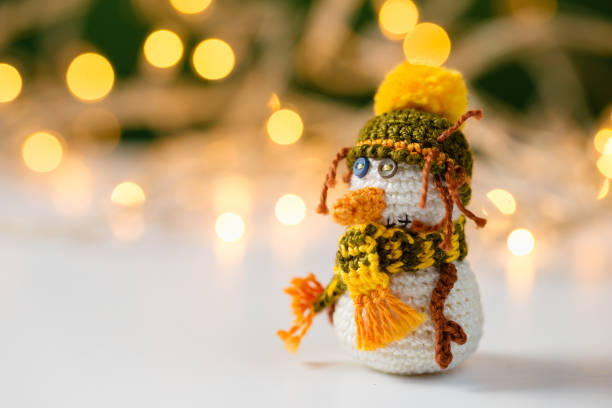 istock Handmade crochet snowman toy with bokeh 892743036