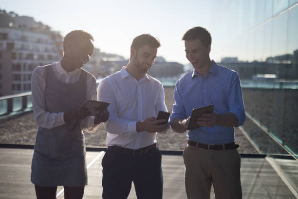 istock Male and female executives using digital and mobile phone 892743250