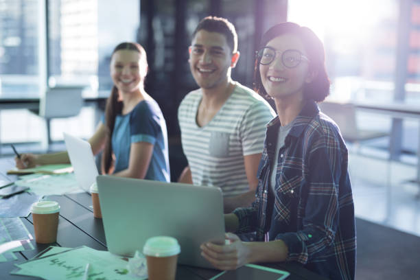 istock Smiling executives working together at desk 892746098