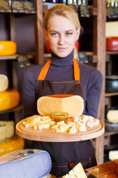istock Cheese platter in shop assistant hands 892748382