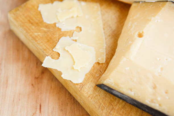 istock Cheese platter, parmesan on natural wooden board 892748572
