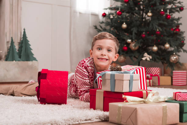 istock boy laying on floor with christmas gifts 892748616