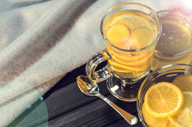 istock Composition from tea with lemon and ginger and yellow sweets 892756594