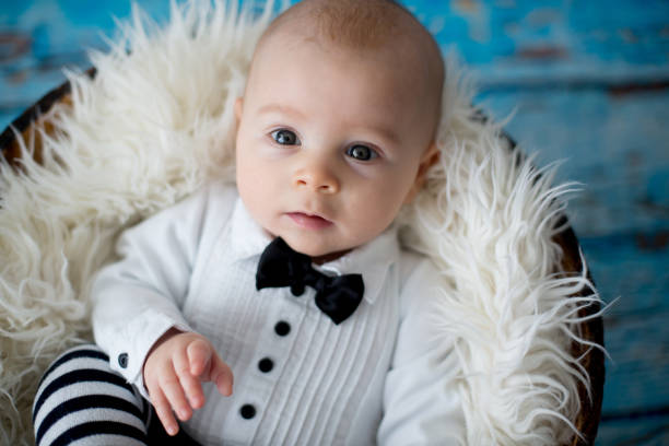 istock Little baby boy with knitted ladybug hat and pants in a basket 892759192