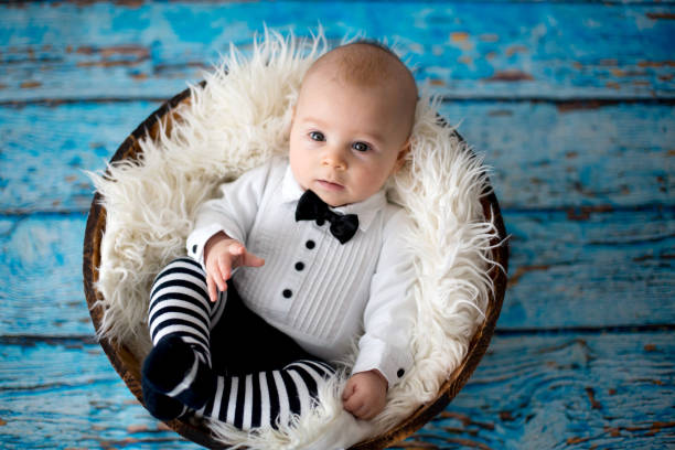 istock Little baby boy with knitted ladybug hat and pants in a basket 892765518