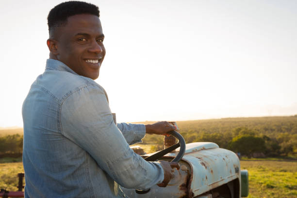 istock Farmer driving tractor at countryside 892779278