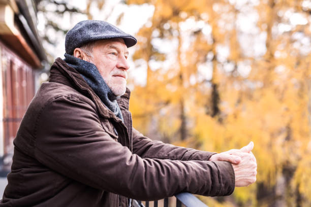 istock Senior man resting on a terrace in autumn nature. 892779726