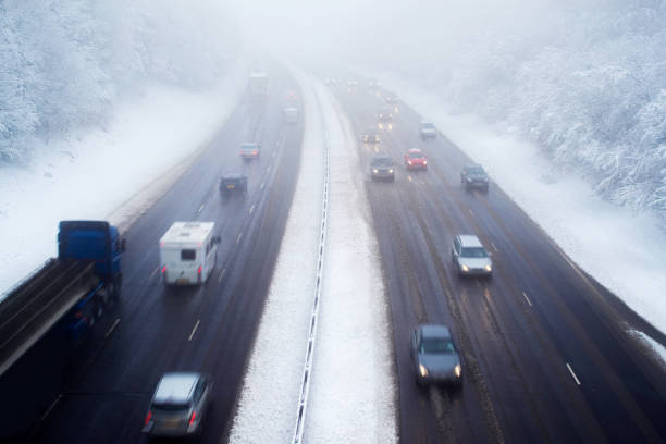 istock Traffic On Motorway During Snow Storm 892787468