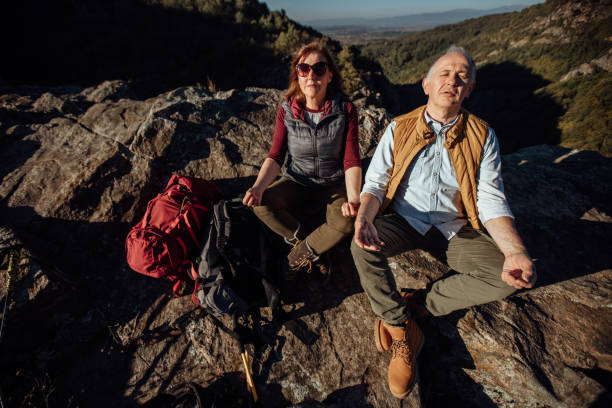 istock Senior couple meditating in nature 892787854