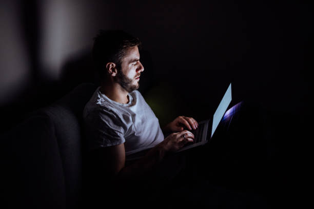 istock Young man working late in bed on a laptop 892790768