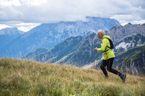 istock Senior man jogging in the mountains 892791272