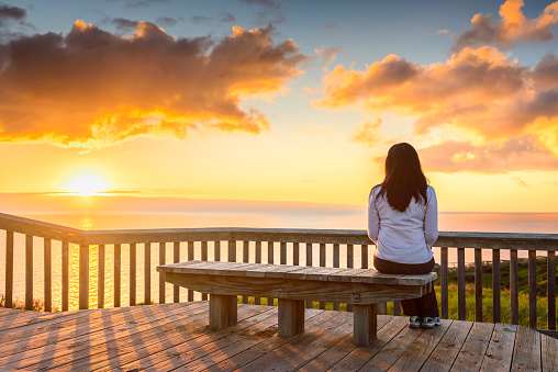 Woman looking at  sunset at Hallett Cove boardwalk in South Australia