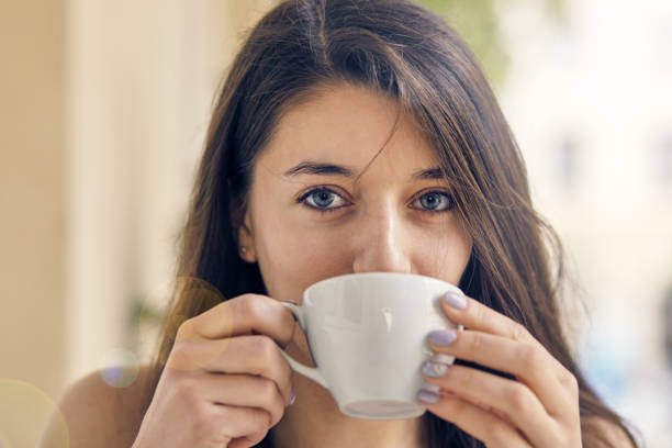 istock young pretty woman drinking coffee 892796952