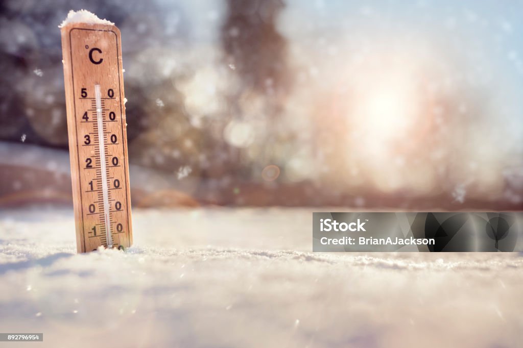 Thermometer in the snow Thermometer in the snow with sub zero minus temperature concept for winter Cold Temperature Stock Photo