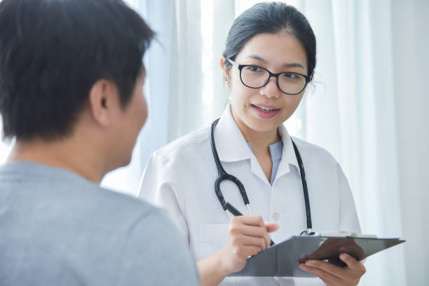 istock Female Doctor examining male patients. 892798068