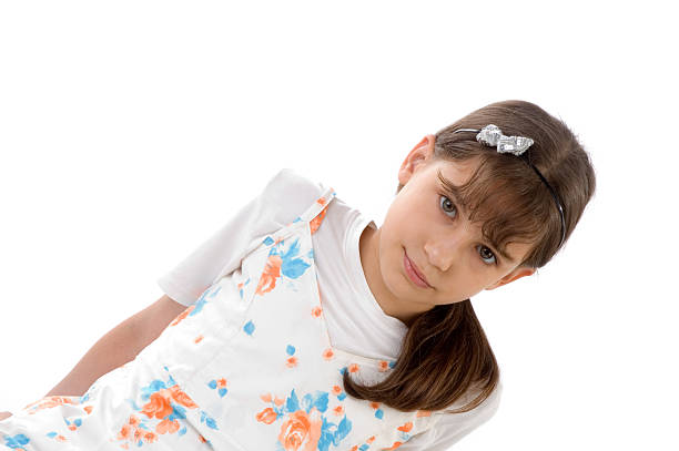 Smiling young girl with a stylish headband posing against a vibrant pink background. Adorable and cheerful, she exudes happiness and confidence, embodying youth and spirit in a charming and lively manner.