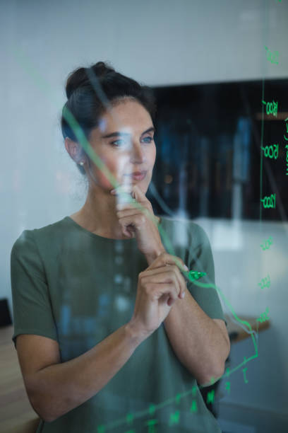 istock Female executive writing on glass 892806860