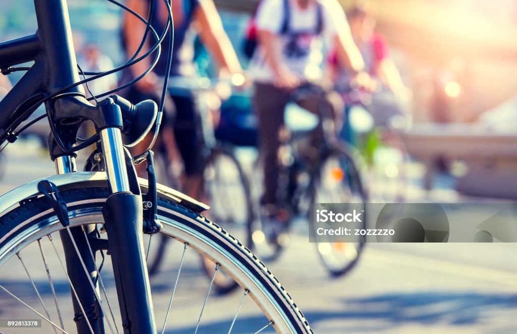 cyclists in the city cyclists in the city in backlit wit blurry background Cycling Stock Photo