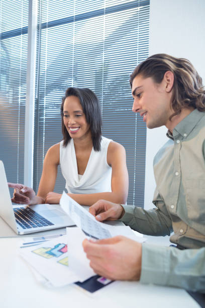 istock Business executives using laptop at desk 892821310