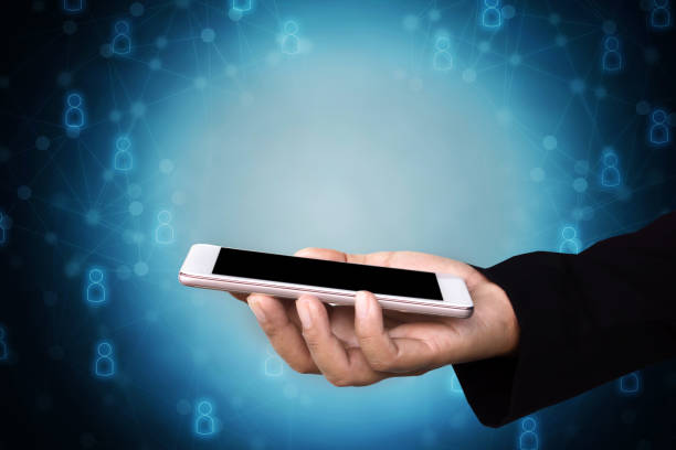 istock business man hand holding smart phone with networking people icon background 892824100