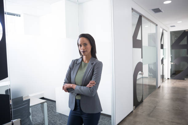 istock Confident businesswoman standing in corridor 892826962