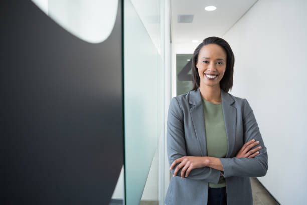 istock Confident businesswoman standing in corridor 892826994