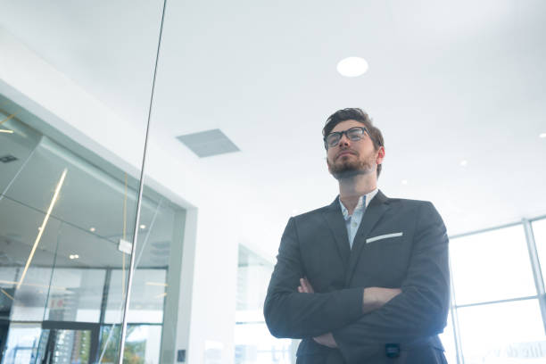 istock Businessman standing with arms crossed in office 892827494