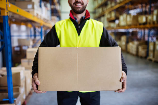 istock Male warehouse worker with a large box. 892827506