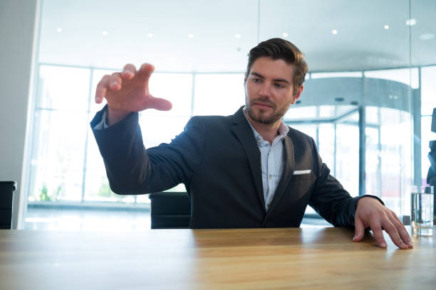 istock Businessman gesturing at desk 892827538