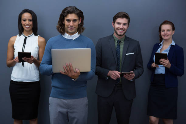 istock Team of business people using electronic devices in office 892834360