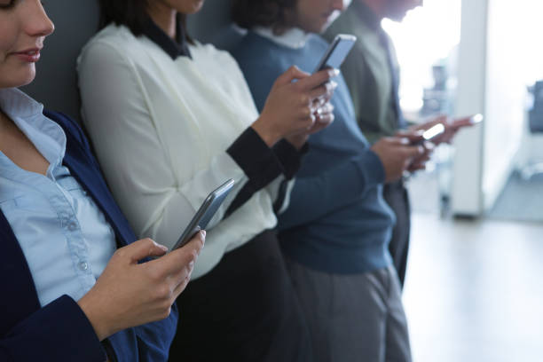 istock Team of business people using mobile phone 892841200